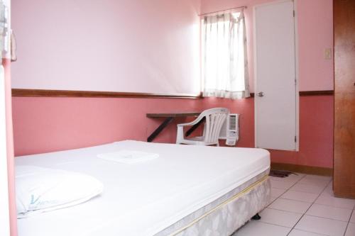 a hospital room with a bed and a chair at GV Hotel - Maasin in Maasin
