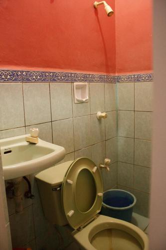 a bathroom with a toilet and a sink at GV Hotel - Maasin in Maasin