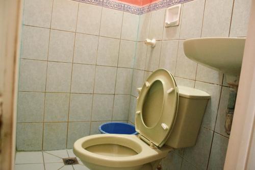 a bathroom with a toilet and a sink at GV Hotel - Maasin in Maasin