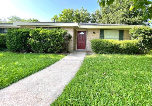 a house with a red door and a sidewalk at Private room in Plano in Plano