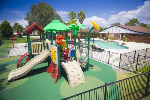 a playground with a slide in a park at Lakeside Forster Holiday Park and Village in Forster