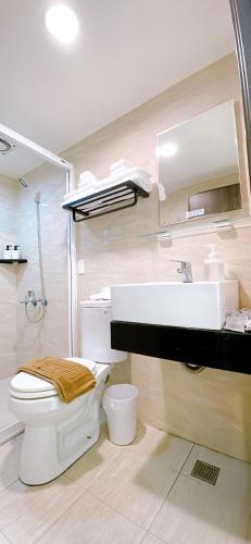 a bathroom with a toilet and a sink at 三弄旅宿3rd Alley Inn in Kaohsiung