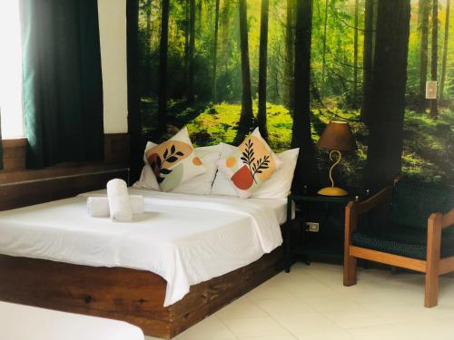a bedroom with two beds and a chair and trees at Casa Generosa in Baguio