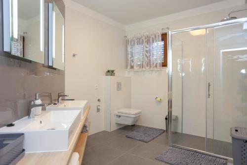 a bathroom with a shower and a sink and a toilet at Apartments with a swimming pool Zrnovnica, Split - 18147 in Žrnovnica