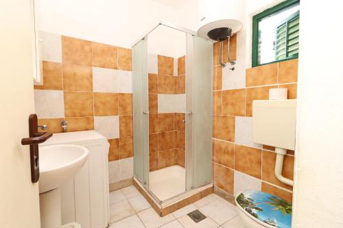 a bathroom with a shower and a sink at Apartments by the sea Prizba, Korcula - 18165 in Prizba