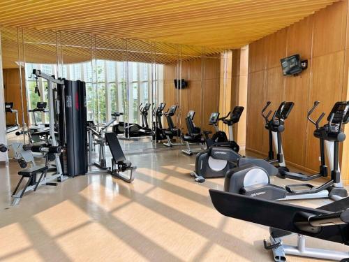 a gym with a bunch of exercise bikes in it at Cozy Studio Suite in Taman Anggrek Residences in Jakarta