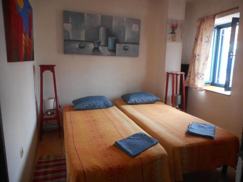 two beds in a room with blue pillows on them at Apartments by the sea Susak, Losinj - 18202 in Susak