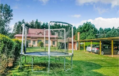 a trampoline in a yard in front of a house at Beautiful Apartment In Kopalino in Kopalino