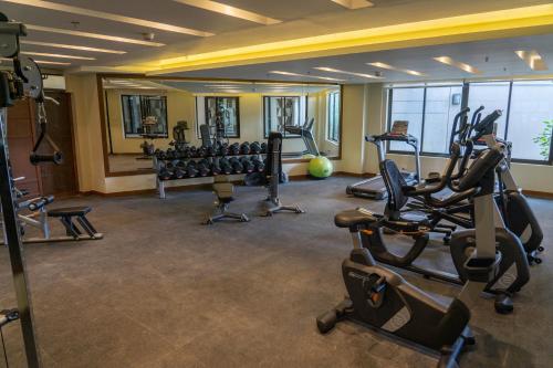a gym with cardio equipment in a hotel room at Bristle Ridge Cozy 2bedroom Residence in Baguio