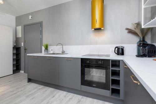a kitchen with a sink and a stove at Apartament Prestige Centrum in Bielsko-Biała