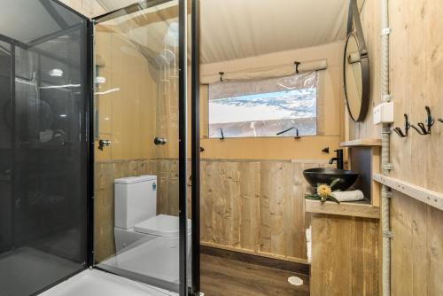 a bathroom with a shower and a toilet at Ballina Beach Nature Resort in Ballina