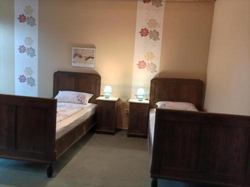 a bedroom with two beds and two night stands at BmB Kirchwalsede Monteurzimmer / Unterkunft in Kirchwalsede