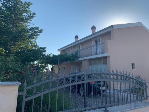 a fence in front of a house at Apartments with parking space Katuni, Zagora - 18344 in Šestanovac
