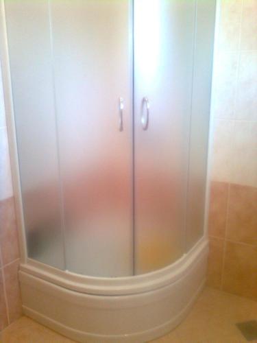 a large white cabinet with glass doors in a bathroom at Apartments with parking space Katuni, Zagora - 18344 in Šestanovac