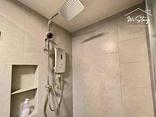 a shower with a shower head in a bathroom at WiStay 4-5PAX Premium Apartment KK City Center in Kota Kinabalu