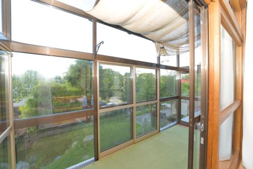an empty room with large windows in a house at Toya Blue in Lake Toya