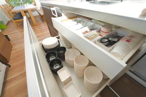 an open refrigerator with plates and dishes in it at Toya Blue in Lake Toya