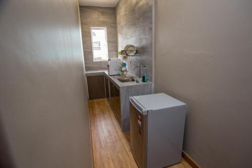 a small bathroom with a sink and a counter at Amoris Grand Event Space in Muar