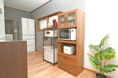 a kitchen with a cabinet with a microwave at Toya Blue in Lake Toya