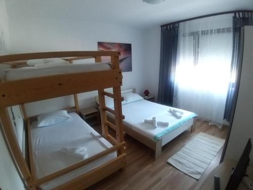 a small room with two bunk beds and a mirror at Apartments with a parking space Kamenjak, Crikvenica - 18348 in Grižane