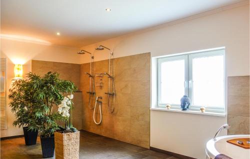 a bathroom with a shower and a sink and a window at Ferienhaus Big Apple in Drochtersen
