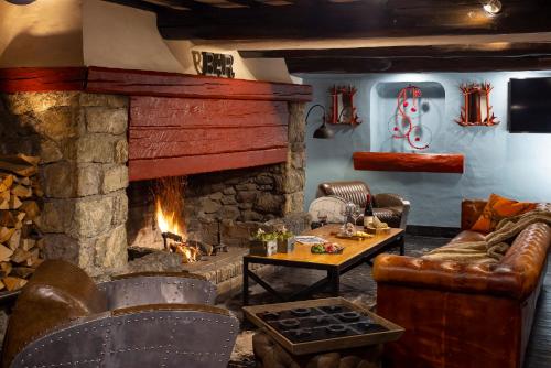 a living room with a couch and a fireplace at Hôtel Courcheneige in Courchevel