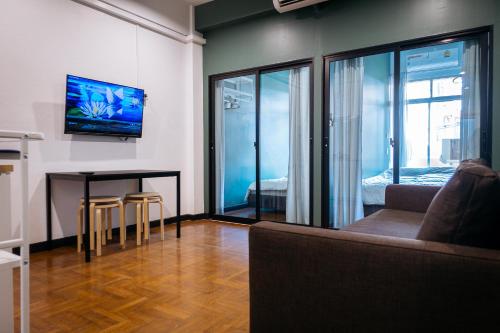 a living room with a couch and a table at T3 TWO Bedrooms WIFI Full kitchen 1 min to BTS in Bangkok