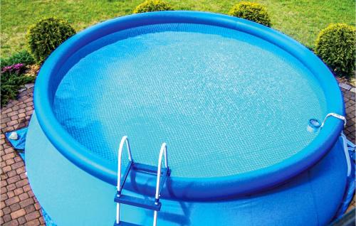 a blue swimming pool sitting on the ground at Lovely Home In Malechowo With Wifi in Malechowo