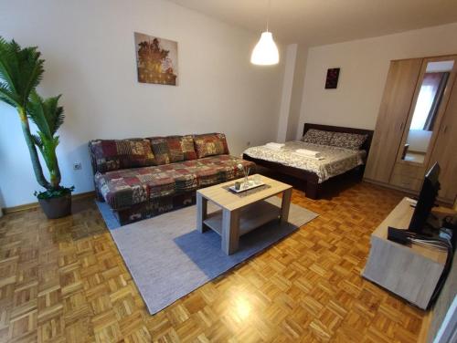 a living room with a couch and a coffee table at Banjica 2 in Voždovac