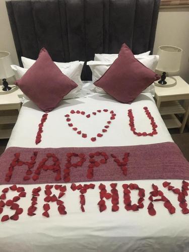 a bed with a heart made out of red roses at Sunnyridge Lodge in East London