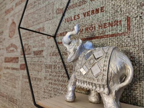 a silver elephant statue sitting on top of a shelf at Banjica 2 in Voždovac
