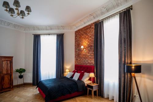 a bedroom with a bed and a brick wall at be HAPPY Apartments in Kraków