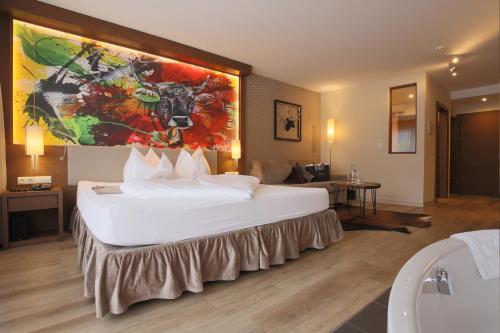 a large white bed in a hotel room at Alpen-Herz Romantik & Spa - Adults Only in Ladis