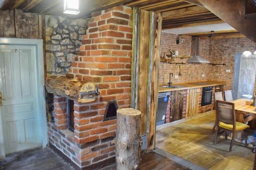 a brick room with a brick oven in a kitchen at Holiday house with a parking space Mrkopalj, Gorski kotar - 18429 in Mrkopalj