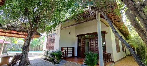 a house with a tree in front of it at Banyan Villa Nha Trang in Nha Trang