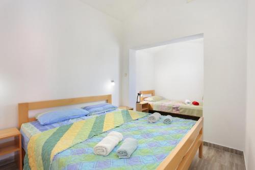 a bedroom with a bed with towels on it at Apartments with a parking space Split - 18214 in Solin