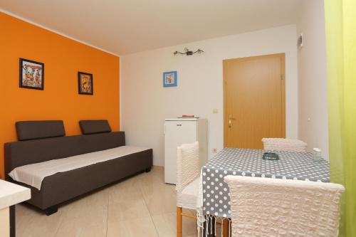 a small room with a bed and a refrigerator at Apartments by the sea Zivogosce - Porat, Makarska - 18218 in Igrane