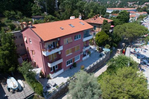 an aerial view of a large pink building at Rooms by the sea Moscenicka Draga, Opatija - 18473 in Mošćenička Draga