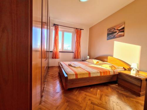 a bedroom with a bed and a window at Apartments by the sea Slatine, Ciovo - 18481 in Slatine