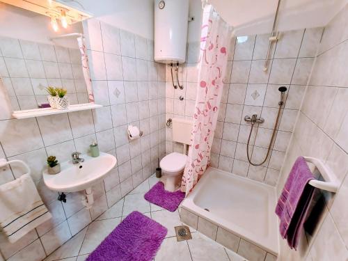 a bathroom with a sink and a toilet and a shower at Apartments by the sea Slatine, Ciovo - 18481 in Slatine