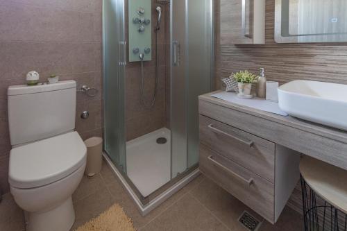 a bathroom with a toilet and a sink and a shower at Seaside luxury villa with a swimming pool Privlaka, Zadar - 18508 in Privlaka