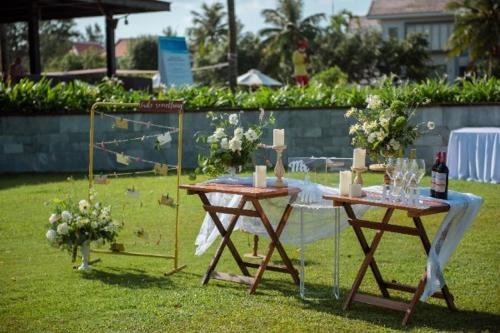 a table with wine bottles and glasses on it at The Ocean Villas Managed by The Ocean Resort in Da Nang