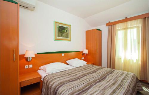 A bed or beds in a room at Nice Apartment In Baska With House A Panoramic View