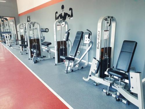 a gym with a row of tread machines at Arena Hotel Lankaran in Lankaran
