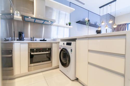a kitchen with a washer and dryer in it at Mcity at Jalan Ampang in Kuala Lumpur