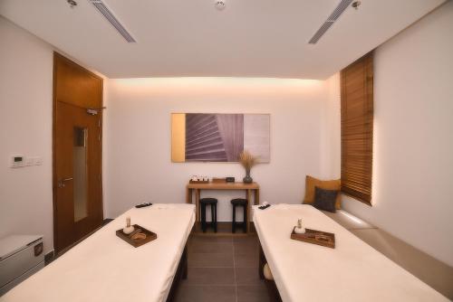 a room with two long tables and a table at The Ocean Villas Managed by The Ocean Resort in Da Nang