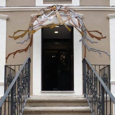 a entrance to a building with areath on the door at Hotel el Jardín de Eugenia in Ribadesella