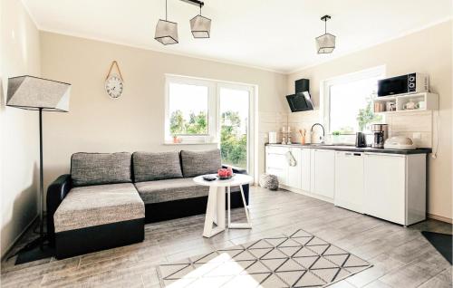 a living room with a couch and a kitchen at 2 Bedroom Cozy Home In Dabki in Dąbki
