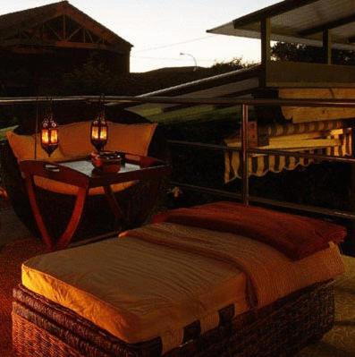 a bedroom with a bed and a table with a table at Hotel el Jardín de Eugenia in Ribadesella