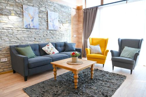 a living room with a couch and two chairs and a table at Villa Letizia near the Bansko Ski Resort in Razlog